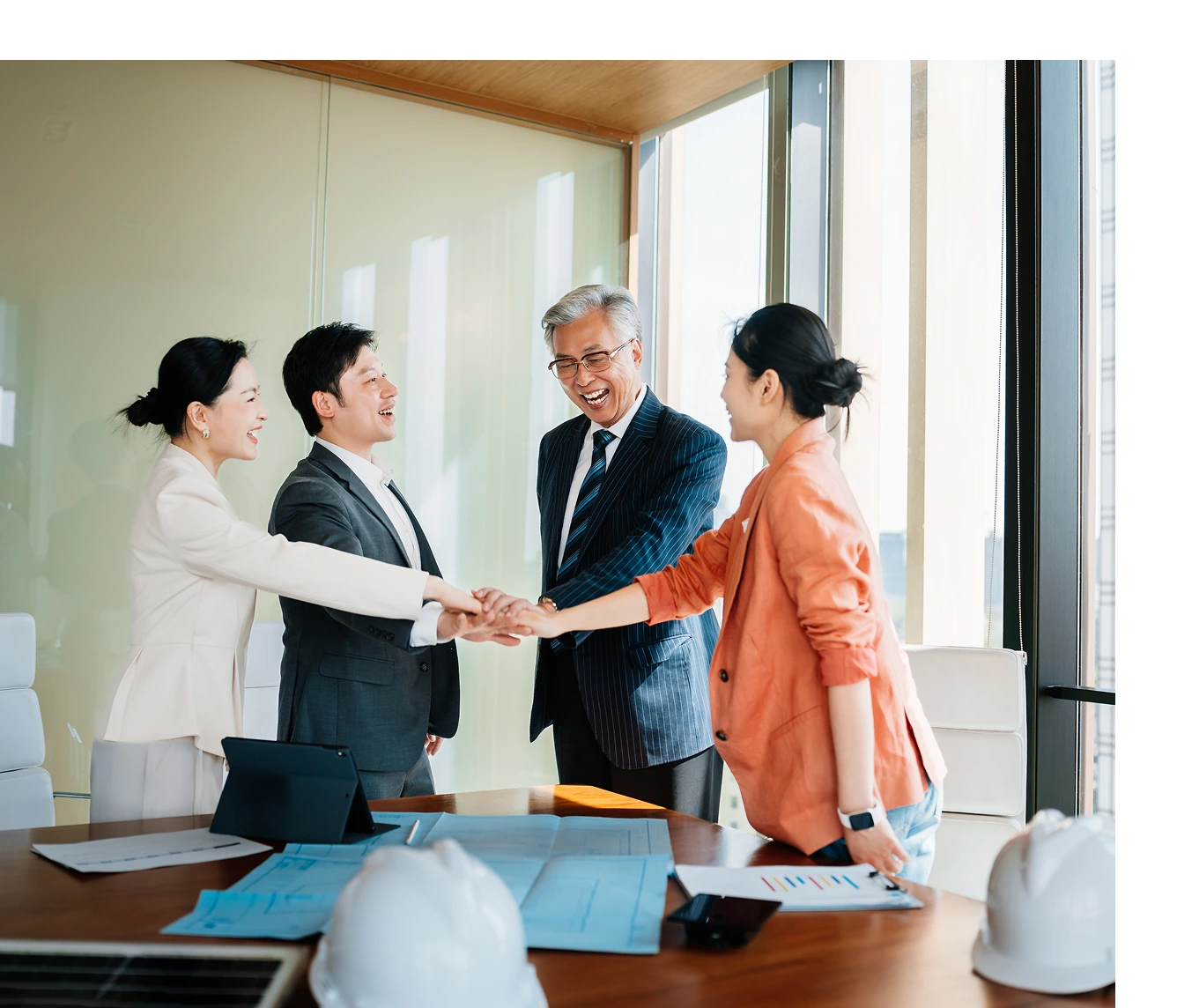 Team shaking hands in office
