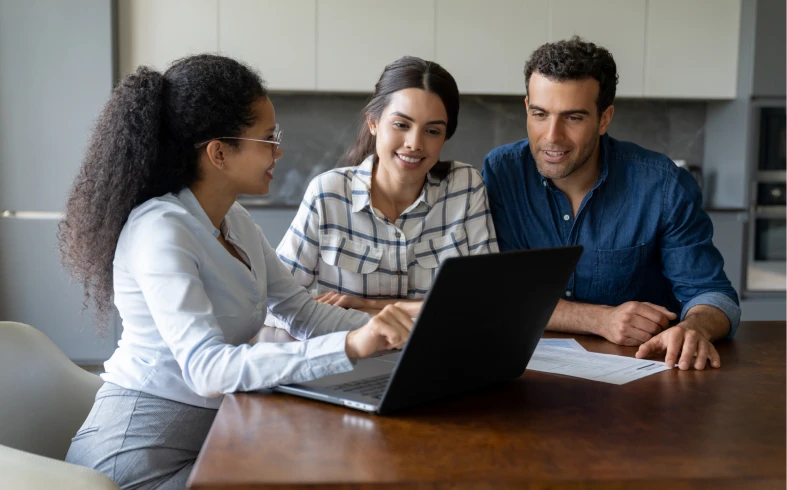 Three people collaborating at a desk