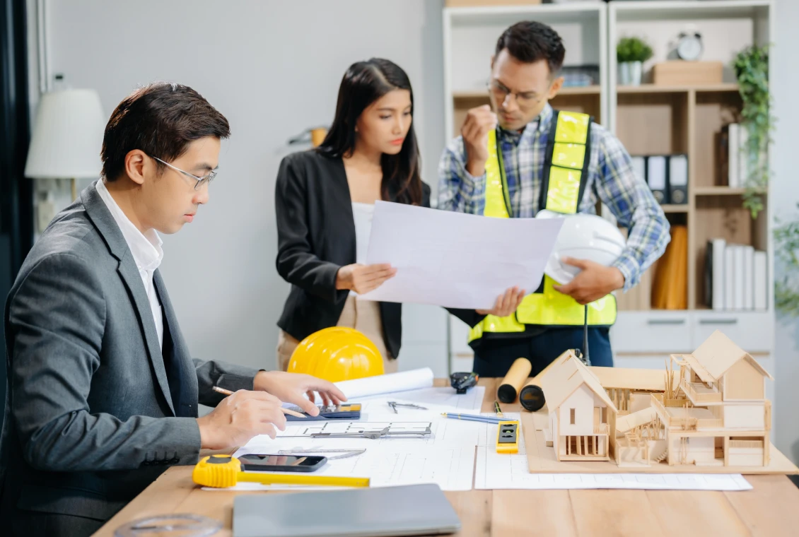 Architects reviewing building plans together